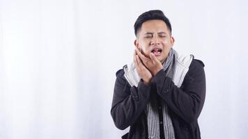 Sick Young Asian Man Suffering from Toothache on White Background photo