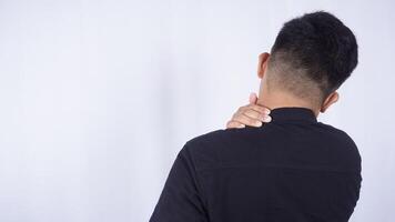 Rear View of Man Do Self Massage at His Shoulder to Release Pain on White Background photo