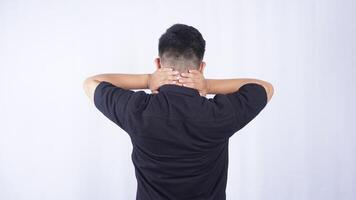Rear View of Man Massaging His Neck to Release Pain on White Background photo