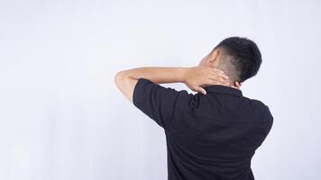 Rear View of Man Touching His Neck Suffering from Pain on White Background photo