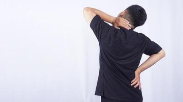 Rear View of Man Feeling Pain in The Neck on White Background photo