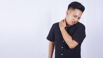 Sick Asian Man Suffering from Shoulder Pain on White Background photo