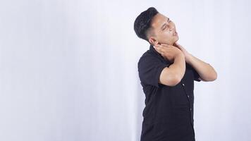 Side View of Asian Man Do Self Massage at His Neck Suffering from Neck Pain on White Background photo