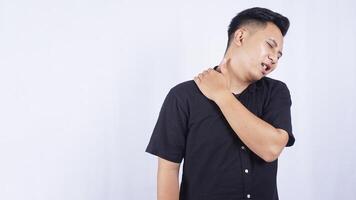 Young Asian Man Suffering from Shoulder Pain on White Background photo