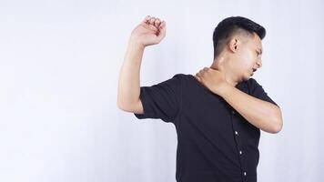 Young Asian Man Suffering from Stiff and Pain Muscle on White Background photo
