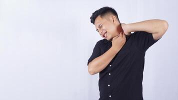 Sick Asian Man Suffering from Stiff and Pain Muscle on White Background photo