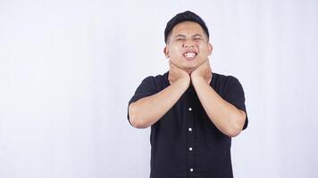 Young Asian Man Suffering from Sore Throat on White Background photo