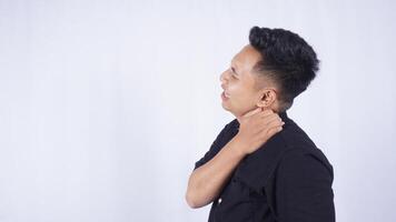 Side View of Sick Asian Man Do Self Massage at His Shoulder to Release Pain on White Background photo