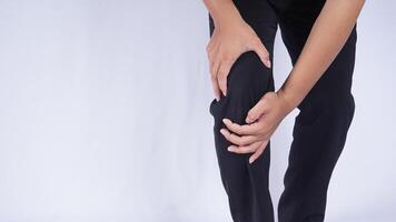 Man Suffering from Knee Injury on White Background photo