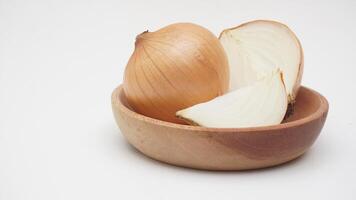 Bulb, Half, and Slice of Onion on Wooden Plate on White Background photo