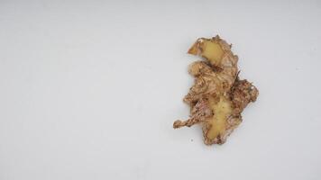 Top View of Peeled Ginger Spice on White Background photo