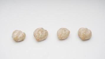 Candlenut Seeds on White Background photo