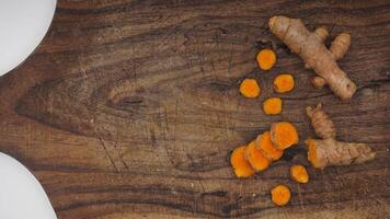 Turmeric Spice on Wooden Cutting Board on White Background photo