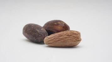 Whole Nutmegs with Nutmeg Seed on White Background photo