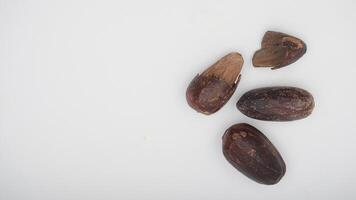 Top View of Whole Nutmeg and Nutmeg with Broken Skin on White Background photo