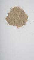 Top View of White Pepper Powder on White Background photo