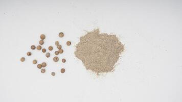 Top View of White Peppercorn Raw and Powder on White Background photo