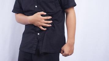 Close Up of Man Touching on His Stomach Suffering from Stomachache on White Background photo