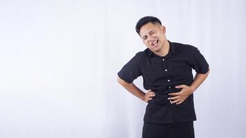 Portrait of Asian Man with Abdominal Pain on White Background photo