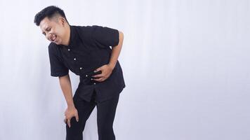 Asian Man Touching on His Stomach Suffering from Abdominal Pain on White Background photo