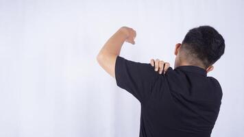 Rear View of Man Suffering from Stiff Muscle with Shoulder Pain on White Background photo