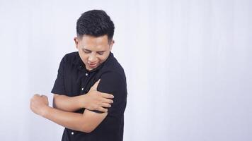 Asian Man with Stiff Muscle on White Background photo