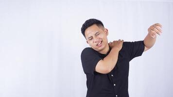 Asian Man Feels Pain in His Shoulder on White Background photo