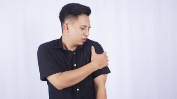 Asian Man with Stiff Shoulder on White Background photo
