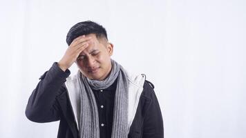 Young Asian Man Feels Pain in His Head on White Background photo