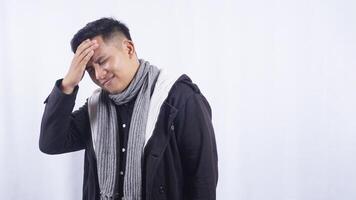 Unhappy Asian Man Feels Pain in His Head photo