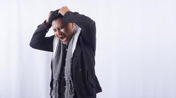 Stressed Asian Man Suffering from Bad Headache on White Background photo