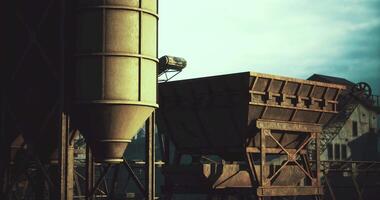 Industrial structures in an abandoned factory setting during daytime video