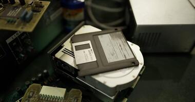 Exploring old technology with circuit boards and floppy disks on a workbench video
