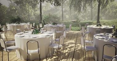 Elegant outdoor wedding setup with tables and greenery in a serene forest video