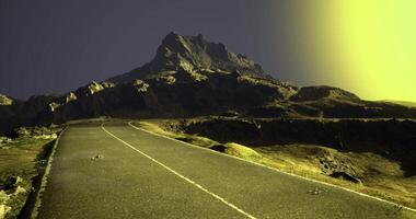 Majestic mountain view along a winding road at dusk under a glowing sky video