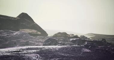 Dramatic rock formations under a hazy sky at a remote landscape video