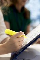 Human resources worker agreeing terms with candidate during job interview, highlighting text on documents. HR employee selecting candidates to work for company, using highlighter marker photo