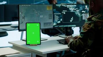 Military team operating in a high tech command post control tower, focusing on surveillance tactics for intelligence gathering. Data protection to manage critical information operations. Camera B. photo