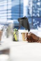 HR worker reviewing candidate, asking questions about qualifications, giving him application form. Close up of applicant writing signature on paperwork after proving enthusiasm for job opportunity photo