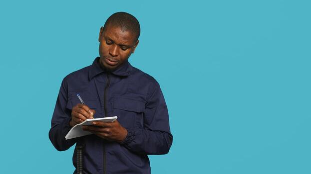 Portrait of security agent holding clipboard, taking notes, receiving orders to secure assigned post, studio background. Guardian maintains logs of observations, handling security breaches, camera A photo