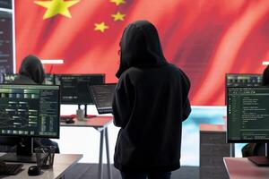 Terrorist person in a Chinese cyber security room hacking national systems, reading fake news and hybrid warfare propaganda. Digital mercenary group spread misinformation and falsification. photo