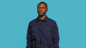 Security guard tasked with preventing criminal activity and detaining suspects stealing, damaging property, or performing other crimes. Portrait of intimidating bodyguard, studio background, camera A photo