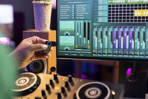 Musical producer using usb stick to edit old audio files on production software, working with mixing console and stereo gear. Audio engineer creating soundtracks for the industry. Close up. photo