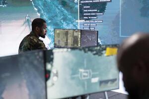 Government intelligence expert in command post handles surveillance tasks, analyzing real time data for field operations and national defense. Security measures for protection. photo
