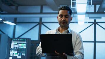 System administrator in data center managing servers, operating systems and software applications. Expert in server hub ensuring networks are secure, up to date, and functioning properly, camera A photo