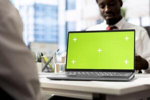 Recruiter using mockup laptop after candidate qualifications aligned with company expectations. HR employee verifying resume on isolated screen notebook before agreeing terms with job applicant photo