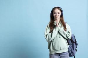 Stressed person doing imploring hand gesture and sulking, being in distress, needing favor, studio backdrop. Desperate young lady soliciting aid, doing please gesturing, requesting assistance photo