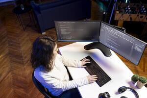 Woman doing software quality assurance, reading source code on computer screen before implementing it. System administrator inspecting coding on desktop PC, looking to fix potential issues photo