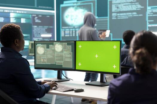 Governmental hackers using green screen in performing cyber security monitoring and threat detection. Examining network security and protection against cyber attacks, national intelligence. photo