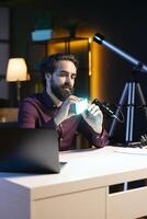 Content creator discussing with viewers about mini led lights during live broadcast on internet. Media star chatting with fans during stream, filming RGB lighting device in studio photo